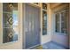 Detailed front door with sidelights and decorative glass that adds an elegant touch at 8248 E Arroyo Hondo Rd, Scottsdale, AZ 85266