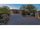 Charming desert home with a large driveway and well-maintained landscaping creating curb appeal at 8248 E Arroyo Hondo Rd, Scottsdale, AZ 85266