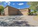 Home's exterior features a wide driveway and desert landscaping, creating a visually appealing scene at 8248 E Arroyo Hondo Rd, Scottsdale, AZ 85266