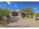 Attractive home exterior with a wide driveway and desert landscaping enhancing the curb appeal at 8248 E Arroyo Hondo Rd, Scottsdale, AZ 85266