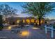 Inviting desert home featuring a stone walkway, desert landscaping and warm exterior lighting at 8248 E Arroyo Hondo Rd, Scottsdale, AZ 85266