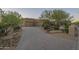 Exterior of home with brick driveway, three car garage, desert landscaping, and unique address marker at 8248 E Arroyo Hondo Rd, Scottsdale, AZ 85266