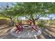 Inviting outdoor fire pit area with comfortable Adirondack chairs and mature landscaping creating a relaxing atmosphere at 8248 E Arroyo Hondo Rd, Scottsdale, AZ 85266