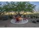 Inviting outdoor fire pit area with comfortable seating and desert landscaping creating a cozy space for evening gatherings at 8248 E Arroyo Hondo Rd, Scottsdale, AZ 85266