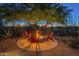 Outdoor fire pit with red Adirondack chairs, perfect for gathering with Gathering and friends at 8248 E Arroyo Hondo Rd, Scottsdale, AZ 85266