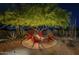 Cozy outdoor fire pit with Adirondack chairs, perfect for relaxing and enjoying the evening at 8248 E Arroyo Hondo Rd, Scottsdale, AZ 85266