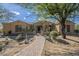 Charming single-story home featuring landscaped front yard with mature trees at 8248 E Arroyo Hondo Rd, Scottsdale, AZ 85266
