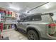 Garage featuring installed shelving, workbench and a SUV parked inside at 8248 E Arroyo Hondo Rd, Scottsdale, AZ 85266