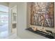 Hallway featuring artwork, sculpture, and a glimpse into the bathroom at 8248 E Arroyo Hondo Rd, Scottsdale, AZ 85266