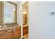 Hallway with a vanity, granite countertop, and a view into an adjacent bedroom at 8248 E Arroyo Hondo Rd, Scottsdale, AZ 85266
