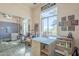 Well-lit hobby room with large windows, crafting stations, and organizational features at 8248 E Arroyo Hondo Rd, Scottsdale, AZ 85266