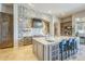 Spacious kitchen featuring a large center island, stone accent wall, and stainless steel appliances at 8248 E Arroyo Hondo Rd, Scottsdale, AZ 85266