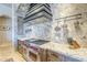 Gourmet kitchen featuring stainless steel appliances and stone backsplash at 8248 E Arroyo Hondo Rd, Scottsdale, AZ 85266