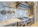 Gourmet kitchen featuring stainless steel appliances and stone backsplash at 8248 E Arroyo Hondo Rd, Scottsdale, AZ 85266