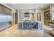 Well-equipped kitchen showcasing a large island with bar stools, stone accent wall, and stainless steel appliances at 8248 E Arroyo Hondo Rd, Scottsdale, AZ 85266