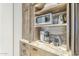 Custom Kitchen featuring stainless steel microwave and custom cabinetry at 8248 E Arroyo Hondo Rd, Scottsdale, AZ 85266