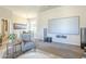 Comfortable living room with a large screen and cozy chair near a dining area, creating an inviting entertainment space at 8248 E Arroyo Hondo Rd, Scottsdale, AZ 85266
