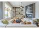 Bright living room boasts a fireplace, shelving, and an eye-catching ceiling fan at 8248 E Arroyo Hondo Rd, Scottsdale, AZ 85266