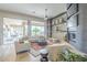 Spacious living room with fireplace, ceiling fan and beautiful outdoor views at 8248 E Arroyo Hondo Rd, Scottsdale, AZ 85266