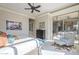 Light-filled bedroom with a sliding glass door, ceiling fan, and a comfortable sitting area at 8248 E Arroyo Hondo Rd, Scottsdale, AZ 85266