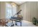 Music room featuring a grand piano, soft lighting, and neutral decor at 8248 E Arroyo Hondo Rd, Scottsdale, AZ 85266