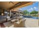 An outdoor living area with an in-ground pool, lounge chairs, and a scenic desert landscape at 8248 E Arroyo Hondo Rd, Scottsdale, AZ 85266
