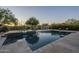 Sparkling pool and spa with stone surround and multiple lounge chairs, perfect for relaxation at 8248 E Arroyo Hondo Rd, Scottsdale, AZ 85266