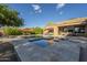 Backyard pool and spa area with a spacious patio, lounge chairs, and umbrellas perfect for entertaining at 8248 E Arroyo Hondo Rd, Scottsdale, AZ 85266