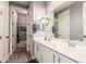 Bright bathroom with a double sink vanity, large mirrors, and a shower and toilet alcove at 850 W Folley St, Chandler, AZ 85225