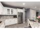 Bright kitchen featuring granite countertops, stainless steel refrigerator, and white cabinetry at 850 W Folley St, Chandler, AZ 85225