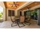 Covered patio with ceiling fans, outdoor seating, and sliding glass doors to the interior space at 850 W Folley St, Chandler, AZ 85225