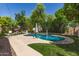Inviting backyard pool area surrounded by lush landscaping and an outdoor dining and seating space at 850 W Folley St, Chandler, AZ 85225