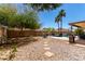 Spacious backyard with lush landscaping, a shimmering pool, and a charming stone pathway, ideal for outdoor enjoyment at 8555 W Purdue Ave, Peoria, AZ 85345