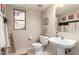 Bright half bath with a window, decorative ladder, and charming Southwestern decor at 8555 W Purdue Ave, Peoria, AZ 85345
