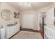 This bedroom features wood floors, white walls, and a dresser with changing table with neutral decor at 8555 W Purdue Ave, Peoria, AZ 85345