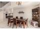 Open dining room featuring a rustic wood table and six chairs beneath a decorative chandelier at 8555 W Purdue Ave, Peoria, AZ 85345