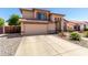 Inviting home exterior showcasing a spacious driveway, well-kept garden, and a classic design at 8555 W Purdue Ave, Peoria, AZ 85345