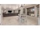 Open kitchen area with breakfast bar seamlessly integrates with the living space at 8555 W Purdue Ave, Peoria, AZ 85345