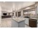 Open-concept kitchen flows seamlessly into living spaces, featuring granite countertops and stainless appliances at 8555 W Purdue Ave, Peoria, AZ 85345