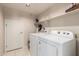 This laundry room has white walls, tile flooring, and new appliances at 8555 W Purdue Ave, Peoria, AZ 85345