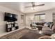 Cozy living room with a large sectional sofa, decorative rug, and ambient lighting at 8555 W Purdue Ave, Peoria, AZ 85345