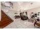Open-concept living area with high ceilings, tile floors, and ample natural light at 8555 W Purdue Ave, Peoria, AZ 85345