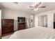 This is a spacious main bedroom that features wood floors and a ceiling fan with a light fixture at 8555 W Purdue Ave, Peoria, AZ 85345