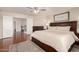 This main bedroom features wood floors, ceiling fan, and a spacious bed with storage drawers underneath at 8555 W Purdue Ave, Peoria, AZ 85345