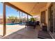 Inviting covered patio features ample seating, a sparkling pool, and a tranquil ambiance perfect for relaxation at 8555 W Purdue Ave, Peoria, AZ 85345