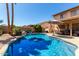 Refreshing backyard pool featuring serene rock accents and clear blue water, perfect for cooling off and relaxation at 8555 W Purdue Ave, Peoria, AZ 85345