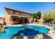 Lush backyard with a refreshing pool, covered patio, and ample seating for entertaining at 8555 W Purdue Ave, Peoria, AZ 85345