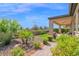Manicured backyard with a covered patio, green lawn, and thoughtfully designed landscaping, perfect for relaxation at 93 E Santa Lucia Ln, Queen Creek, AZ 85140