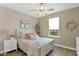 Cozy bedroom with a ceiling fan, plush decor, and a window view at 93 E Santa Lucia Ln, Queen Creek, AZ 85140
