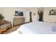 Cozy bedroom featuring neutral paint, soft bedding, a dresser, and a mounted TV for relaxing at 93 E Santa Lucia Ln, Queen Creek, AZ 85140